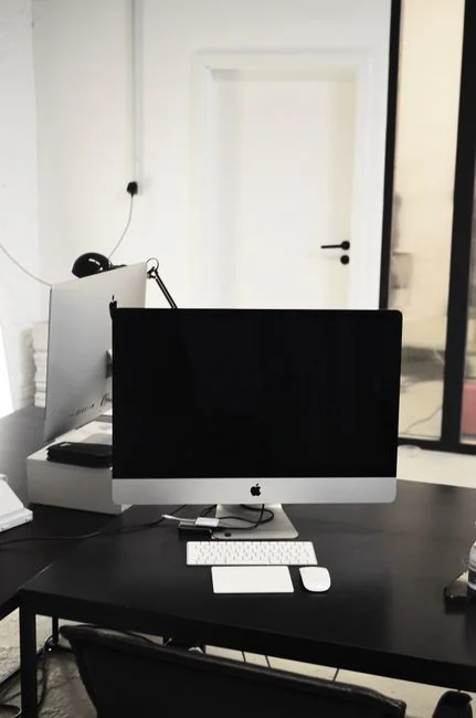 Un écran d’ordinateur moderne affichant un travail de web design, avec des visuels créatifs dans un espace de travail.